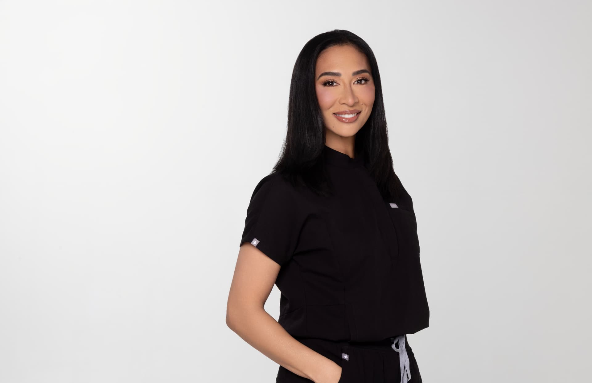 Dr. Sheena Kawamoto, DMD, portrait in black scrubs